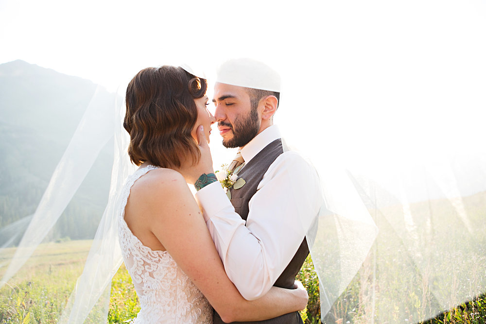 Image of photo of bride and groom under veil